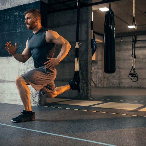 Man exercising with resistance bands in a gym setting